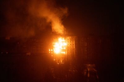 A fire burns at an apartment building after it was hit by shelling in Mariupol. AP Photo