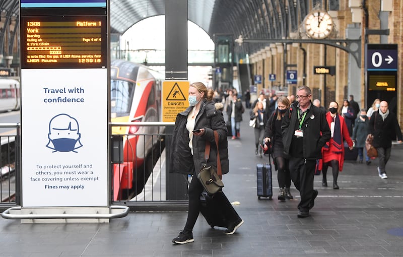 Rail travellers arrive at Kings Cross Station in London. EPA