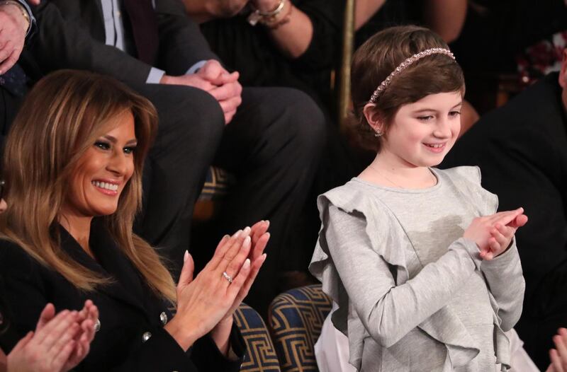 Melania Trump applauds with cancer survivor Grace Eline as she is mentioned byDonald Trump. Reuters