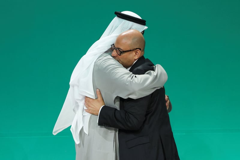 Cop28 President Dr Sultan Al Jaber hugs UN climate change executive secretary Simon Stiell at the plenary session, in Dubai. Reuters