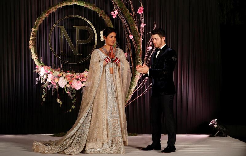 Newlyweds Priyanka Chopra, 36, and Nick Jonas, 26, pose for a photograph during a reception at a hotel in New Delhi on December 4, 2018. Photo: Reuters