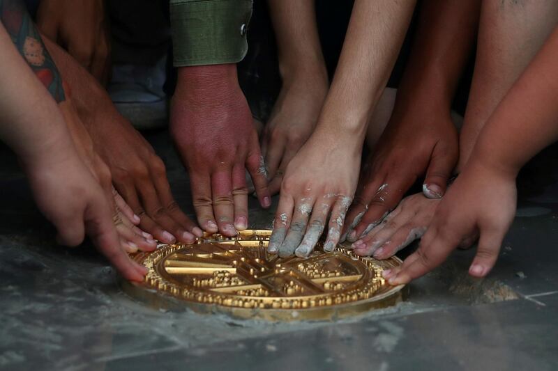 Student leaders install a plaque declaring "This country belongs to the people" during a mass rally to call for the ouster of Prime Minister Prayuth Chan-Ocha and reforms in the monarchy, near the Grand Palace in Bangkok, Thailand. Reuters