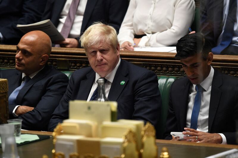 UK Prime Minister Boris Johnson is flanked by then health secretary Sajid Javid, left, and then chancellor Rishi Sunak in Parliament in September 2021. AFP