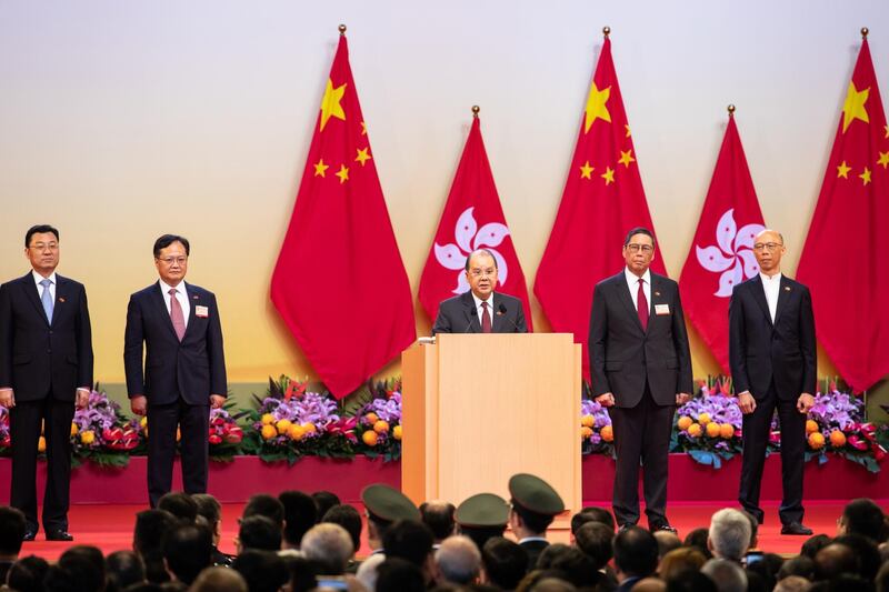 In Hong Kong, Matthew Cheung, Hong Kong's chief secretary, center, speaks during a ceremony to mark the 70th anniversary of the People's Republic of China. Bloomberg