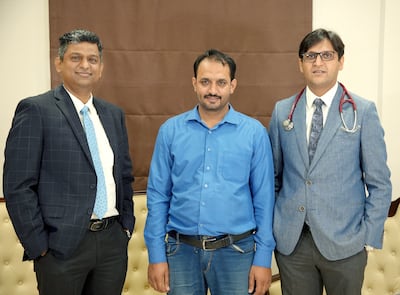 Mian Khan, centre, with Dr Vaibhav Gorde, left, and Dr Rahul Chaudhary. Photo: Burjeel Hospital
