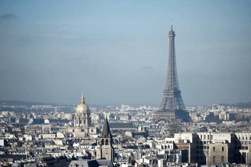 The Eiffel Tower and the dome of Les Invalides, are seen along the skyline of the French capital Paris from the tower at the Notre Dame Cathedral on March 14, 2017. - Paris in December 2016 suffered from a high air pollution index. (Photo by PHILIPPE LOPEZ / AFP)