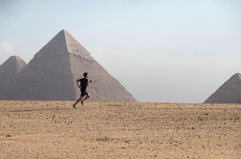 A participant runs near the Giza Pyramids during a race of the Pyramids Half Marathon at the Giza Plateau, Giza, Egypt.  EPA