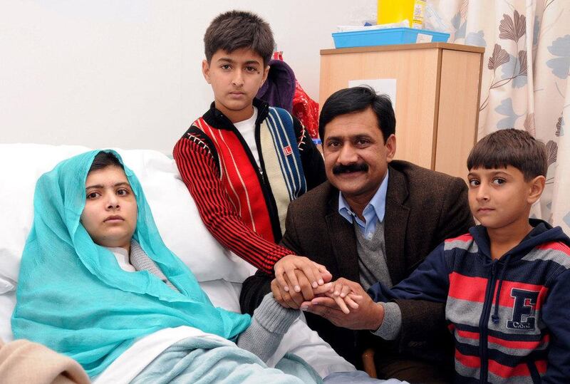 Malala with her family on October 26, 2012, her brothers Khushal Khan, third right, and Apal Kha, right, and father Ziauddin Yousufzai, at the hospital in Birmingham. Queen Elizabeth Hospital / University Hospitals Birmingham / AFP Photo