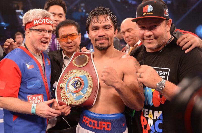 Manny Pacquiao of Philippines celebrates victory over Timothy Bradley of US  following their  WBO World Welterweight Championship title match at the MGM Grand Arena in Las Vegas, Nevada on April 12, 2014.  Pacquiao went on to wina 12-round unanimous decision over  Bradley to avenge his controversial 2012 loss to the previously unbeaten American. AFP PHOTO / JOE KLAMAR (Photo by JOE KLAMAR / AFP)