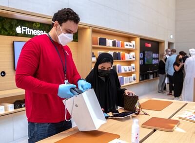 A customer with her new iPhone 13 Pro at the Apple store in Yas Mall, Abu Dhabi. Victor Besa / The National.