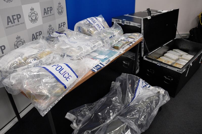 The seized drugs, cash and weaponry seen at the Australian Federal Police headquarters in Sydney. Dan Himbrechts / EPA