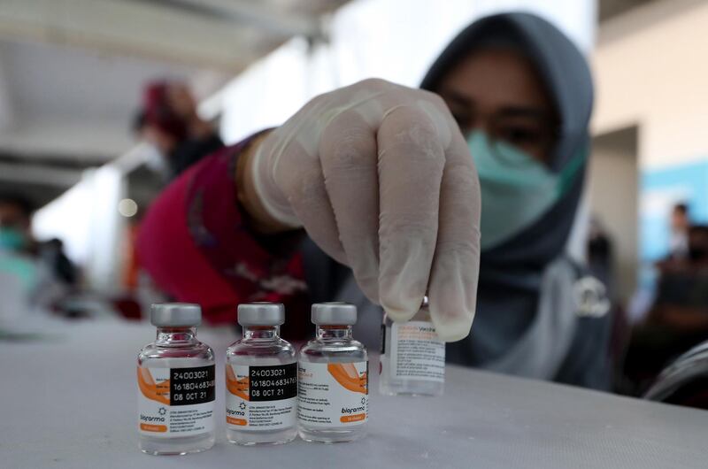 A health worker shows vials containing the Sinovac Covid-19 vaccine at Pakansari Stadium in Bogor, West Java, Indonesia. EPA
