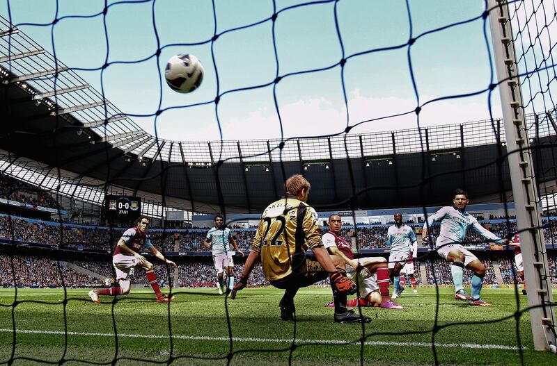 MANCHESTER, ENGLAND - APRIL 27: Sergio Aguero of Manchester City beats Jussi Jaaskelainen of West Ham United to score the opening goal during the Barclays Premier League match between Manchester City and West Ham United at the Etihad Stadium on April 27, 2013 in Manchester, England. (Photo by Alex Livesey/Getty Images)