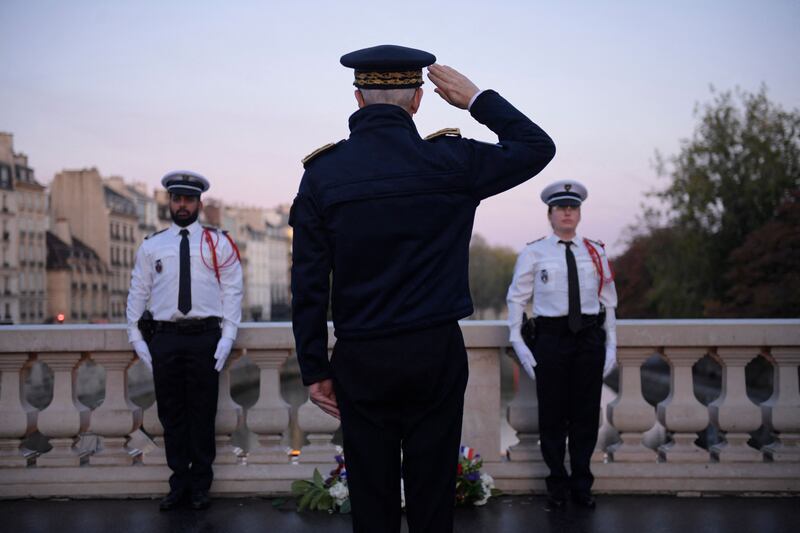 Paris police prefect Didier Lallement pays his respects on the Saint Michel bridge in Paris during a ceremony to mark the 60th anniversary of a deadly operation by Paris police on a protest by Algerians.  AFP