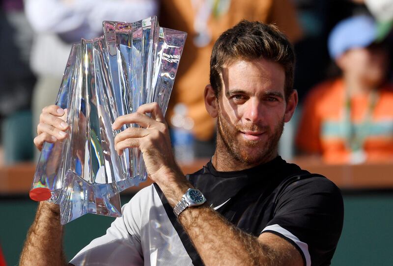 Juan Martin del Potro, of Argentina, holds up his trophy after defeating Roger Federer, of Switzerland, during the men's final at the BNP Paribas Open tennis tournament Sunday, March 18, 2018, in Indian Wells, Calif. Del Potro won 6-4, 6-7 (8), 7-6 (2). (AP Photo/Mark J. Terrill)