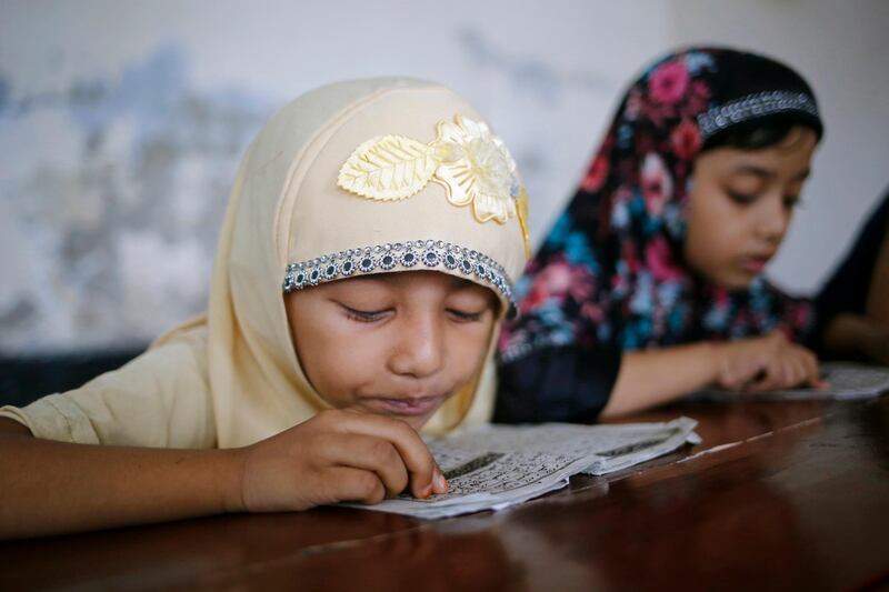 Bangladeshi Muslim girls read the holy Koran at the Madrasa in Dhaka. EPA