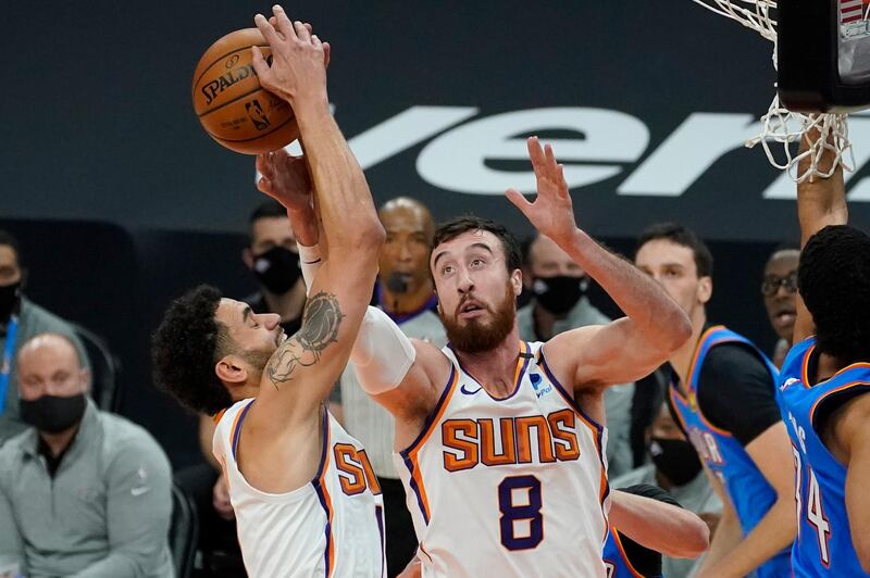Abdel Nader and Phoenix Suns teammate Frank Kaminsky reach for a rebound against the Oklahoma City Thunder. AP