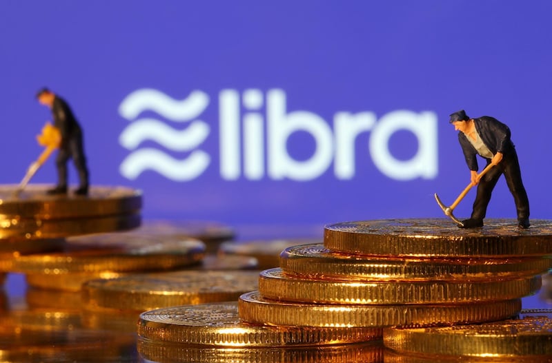 FILE PHOTO: Small toy figures are seen on representations of virtual currency in front of the Libra logo in this illustration picture, June 21, 2019. REUTERS/Dado Ruvic/File Photo