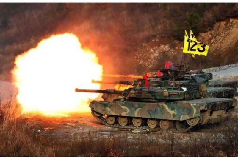 South Korean tanks fire rounds during military exercises on the Seungjin training field in Pocheon, in the north-east of the country, yesterday.