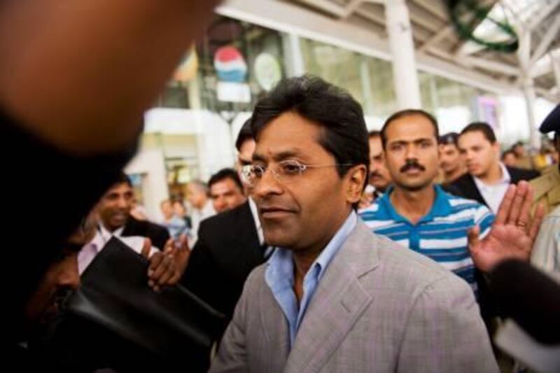 (FILES) In this picture taken on April 28, 2010, suspended Indian Premier League (IPL) Chairman Lalit Modi (C) arrives at Indira Gandhi International Airport's domestic terminal in New Delhi. Lalit Modi has taken India's cricket bosses to court over his suspension as head of the scandal-hit Indian Premier League, a report said July 8. AFP PHOTO/Manpreet ROMANA/FILES *** Local Caption ***  970983-01-08.jpg