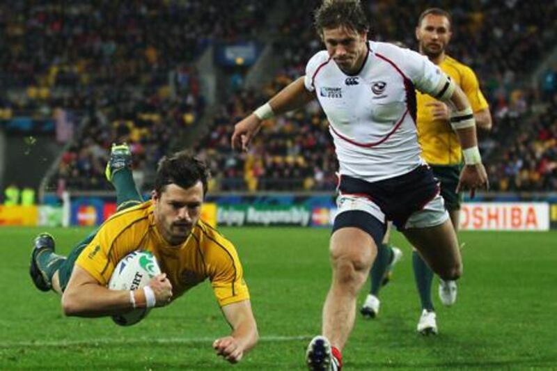 WELLINGTON, NEW ZEALAND - SEPTEMBER 23:  Adam Ashley-Cooper of the Wallabies dives over to score his team's seventh try during match 23 of the IRB 2011 Rugby World Cup between Australia and the USA at Wellington Regional Stadium on September 23, 2011 in Wellington, New Zealand.  (Photo by Cameron Spencer/Getty Images)