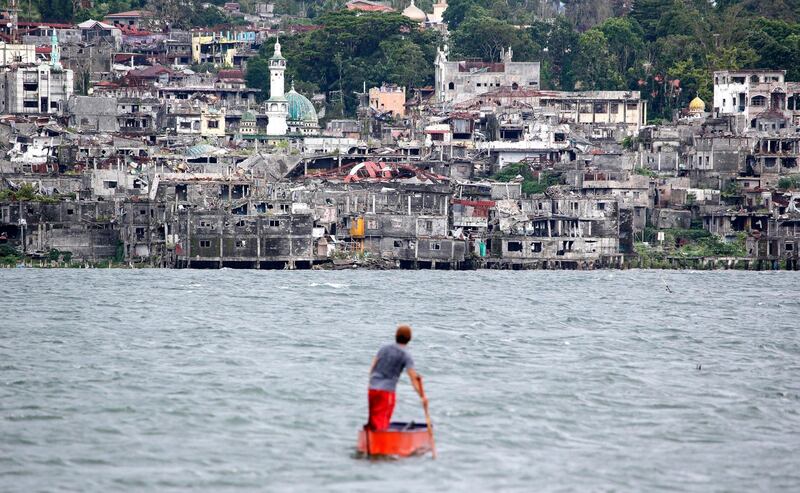 A man fishes near the ruins of Marawi city, southern Philippines. Aaron Favila / AP Photo