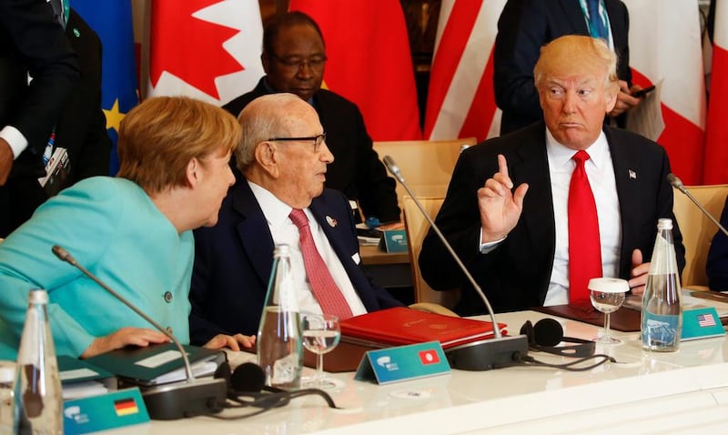 US President Donald Trump making his point to German Chancellor Angela Merkel and Tunisia's President Beji Caid Essebsi at the G7 Summit expanded session in Taormina, Sicily, Italy on May 27, 2017. Jonathan Ernst / Reuters