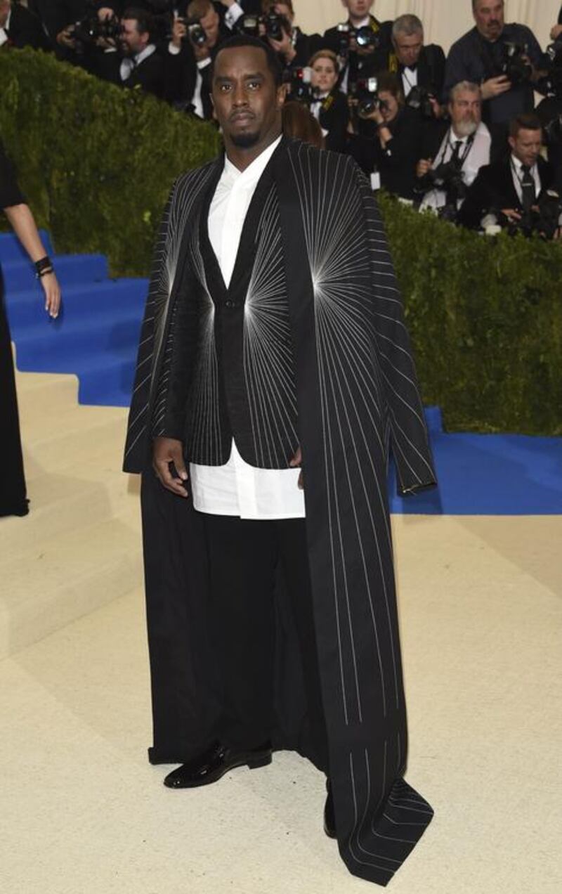 Sean “Diddy” Combs accessorises his suit with a floor-length cape and Christian Louboutin shoes. Evan Agostini / Invision / AP