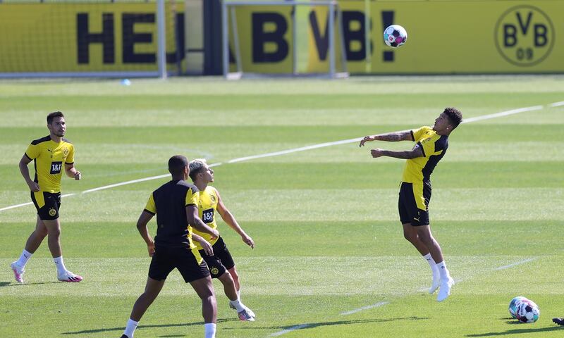 Dortmund's Jadon Sancho, right, heads the ball during training. EPA