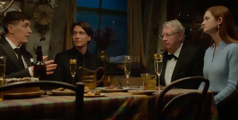 The Weasley family reunite around the dinner table. From left, James Phelps (Fred Weasley), Oliver Phelps (George Weasley), Mark Williams (Arthur Weasley) and Bonnie Wright (Ginny Weasley).