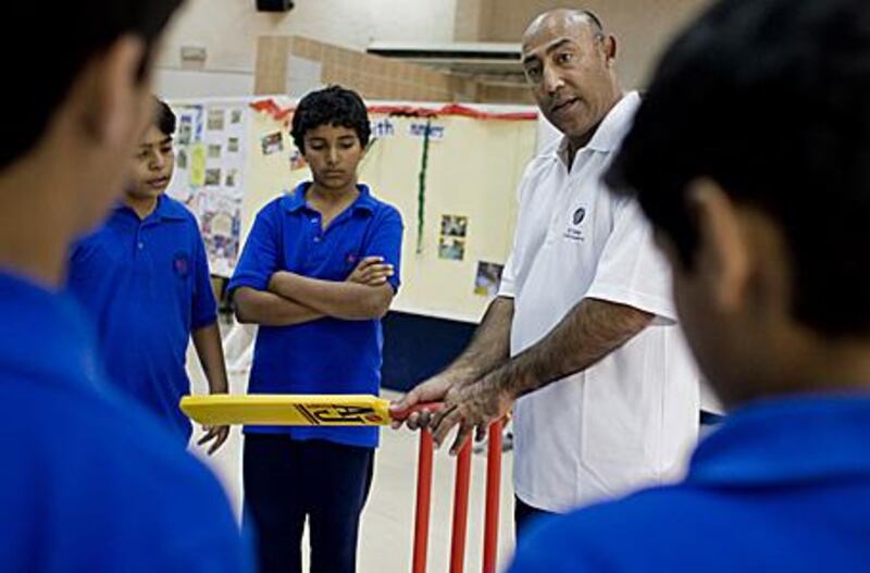 The former Pakistan Test player Mudassar Nazar teaches a group of children from the Al Khaleej School in Dubai.