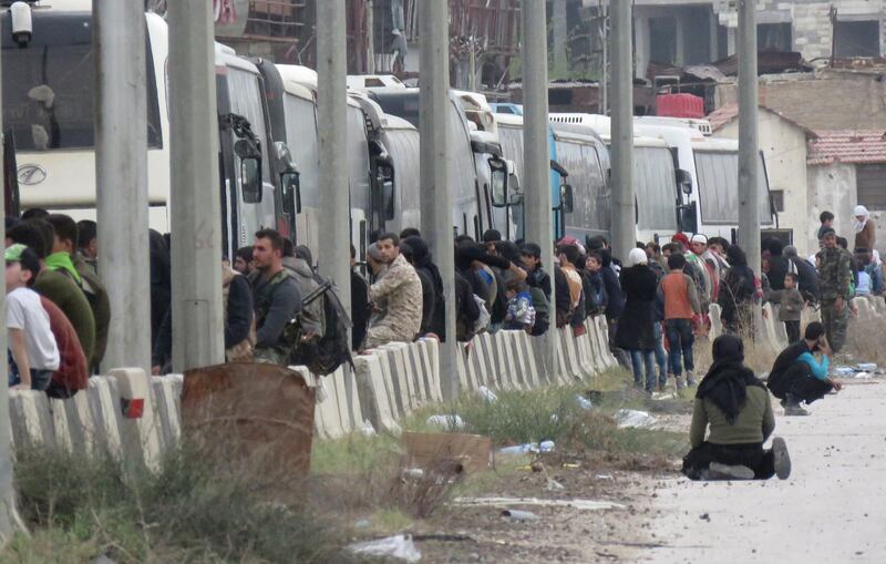 Hundreds of fighters and civilians from Harasta in Syria’s Eastern Ghouta board busses on March 23, 2018 after a deal was struck with the opposition to evacuate a second pocket of the rebel enclave on the outskirts of Damascus. AFP