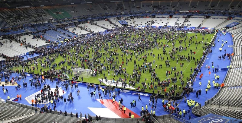 Spectators spill onto the pitch of the Stade de France stadium after three suicide bombers blew themselves up outside the stadium where France were playing Germany in an international football match. Michel Euler/AP Photo