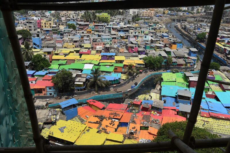 Houses painted in bright colours at a fishing area in Mumbai. Mumbai's slums are getting a colourful makeover thanks to an organisation that aims to change how people perceive deprived areas in India's financial capital. Punit Paranjpe / AFP