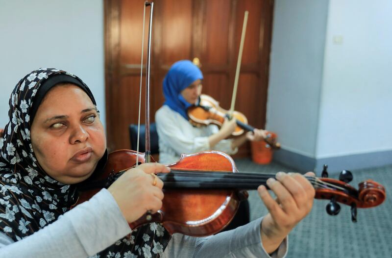 Members of Al Nour Wal Amal (Light and Hope) chamber orchestra for blind women plays during a practice session in Cairo, Egypt. Reuters