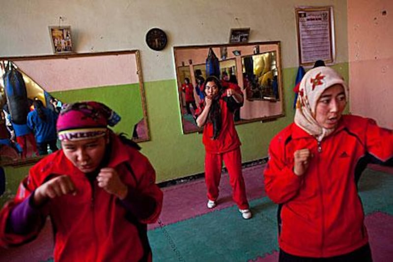 Afghan women train inside the Ghazi Stadium in Kabul. Female boxers are unusual in most countries, but especially in Afghanistan, where two sisters have been threatened they will be kidnaped if they continue to pracitse the sport.