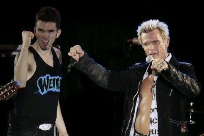 The Seattle musician Michael Henrichsen, left, convinced the rock star Billy Idol to play at his birthday party Friday. Ted S Warren / AP Photo