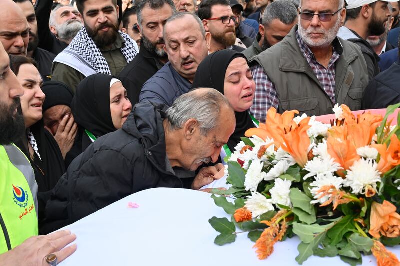 Relatives and friends of Farah Omar and Rabih Al Maamari mourn at their funeral outside the Al Mayadeen TV channel headquarters in Beirut. EPA
