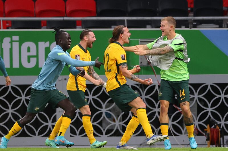 Australia's midfielder Jackson Irvine, second right, celebrates with teammates after scoring the opener. AFP