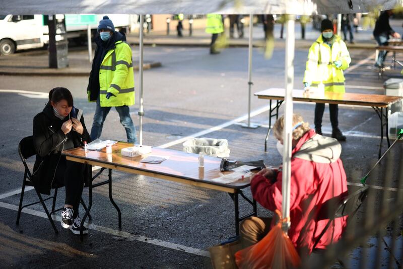 People self-administer Covid-19 swab tests in Ealing, West London. Reuters