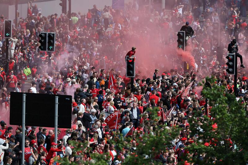 Liverpool's supporters cheer as they arrive to attend an open-top bus parade of the Jurgen Klopp' team. AFP