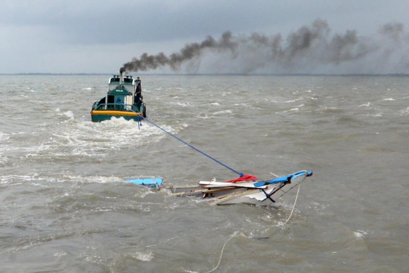 A tugboat hauls the wreckage of one of three boats. Leo Solinap / EPA