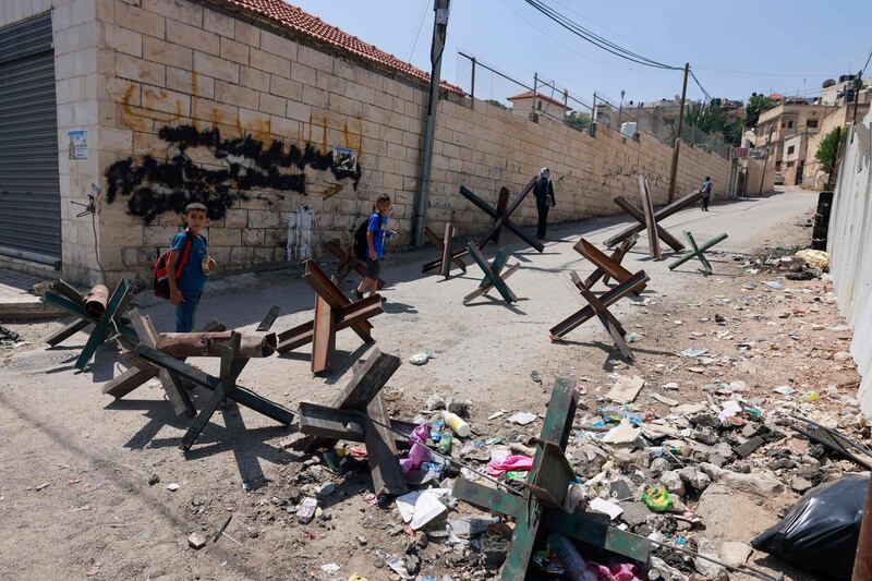 Children on a blocked road after an Israeli military raid in Jenin in the occupied West Bank on September 4. AFP