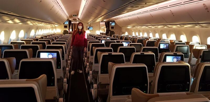Rula Jarallah stands amid empty economy seats on-board an Etihad flight from Geneva to Abu Dhabi on Saturday. She and her husband, Sa-ed, were the only passengers on the plane. Courtesy: Sa-ed Jarallah