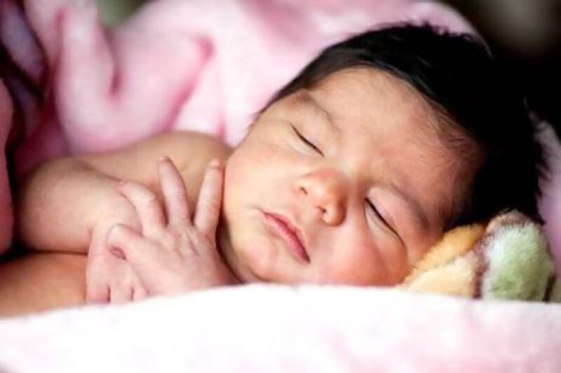 A new baby typically feeds between eight and 12 times every 24 hours, which leaves little time for sleep. iStockphoto