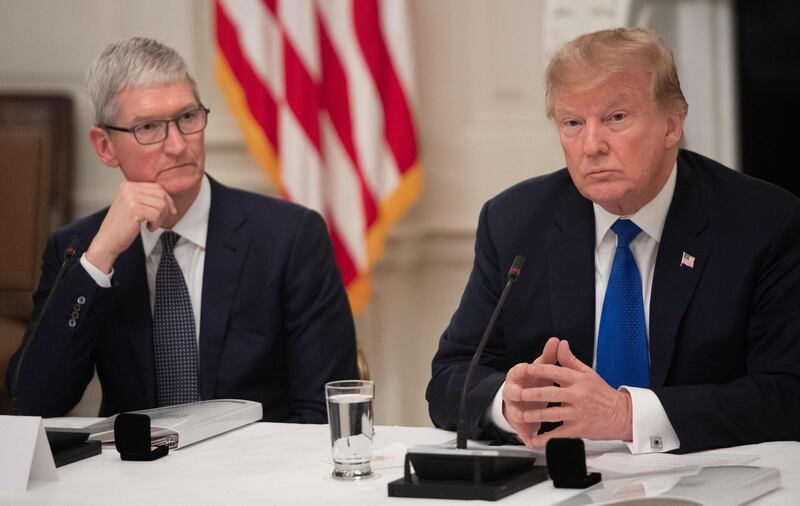 (FILES) In this file photo taken on March 06, 2019 US President Donald Trump speaks alongside Apple CEO Tim Cook (L) during the first meeting of the American Workforce Policy Advisory Board in the State Dining Room of the White House in Washington, DC. Donald Trump said August 16, 2019, that tech giant Apple would be spending "vast sums" of money in the US in a tweet ahead of a dinner meeting with its CEO Tim Cook. / AFP / SAUL LOEB
