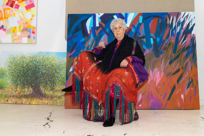 Samia Halaby pictured in 2020 in front of her artwork. Photo: Lara Atalla