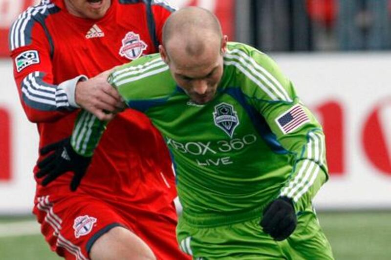 Toronto FC defender Jim Brennan (L) grabs Seattle Sounders FC midfielder Freddie Ljungberg during the first half of their MLS soccer match in Toronto April 4, 2009. 

   REUTERS/ Mike Cassese   (CANADA SPORT SOCCER)

Picture Supplied by Action Images