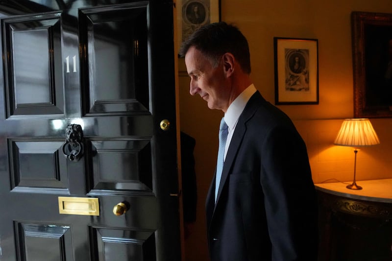 Mr Hunt makes his way out of No 11 Downing Street. AFP