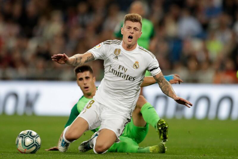 Real Madrid's Toni Kroos is tackled from behind. AP